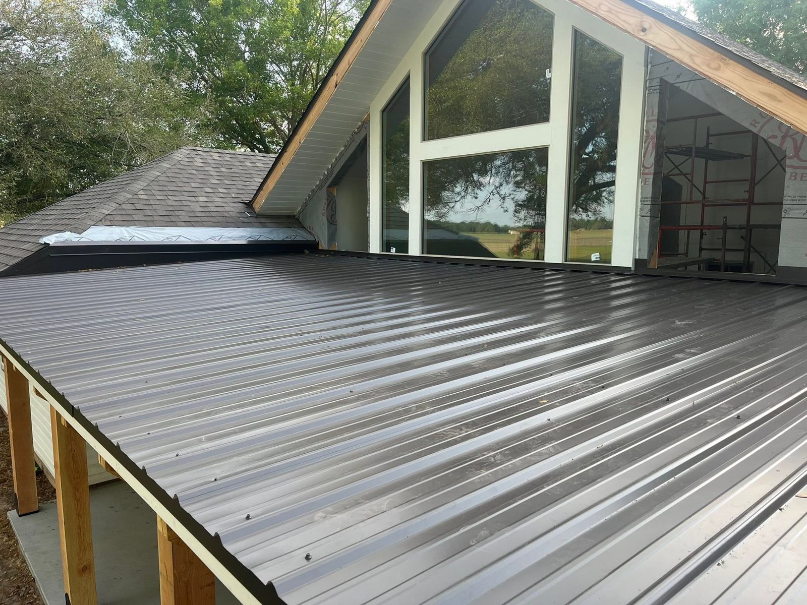 Home addition with tall gable windows and a new metal porch roof
