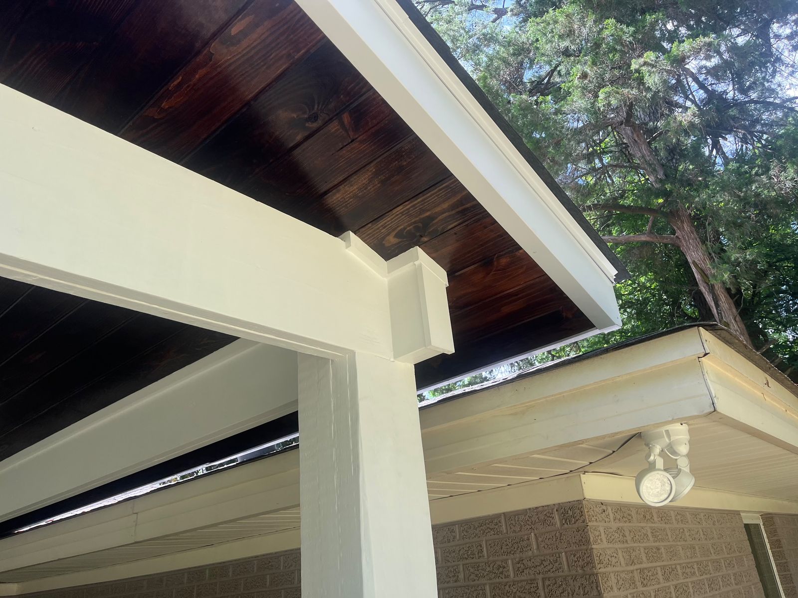 Stained ceiling and white trim on a patio cover