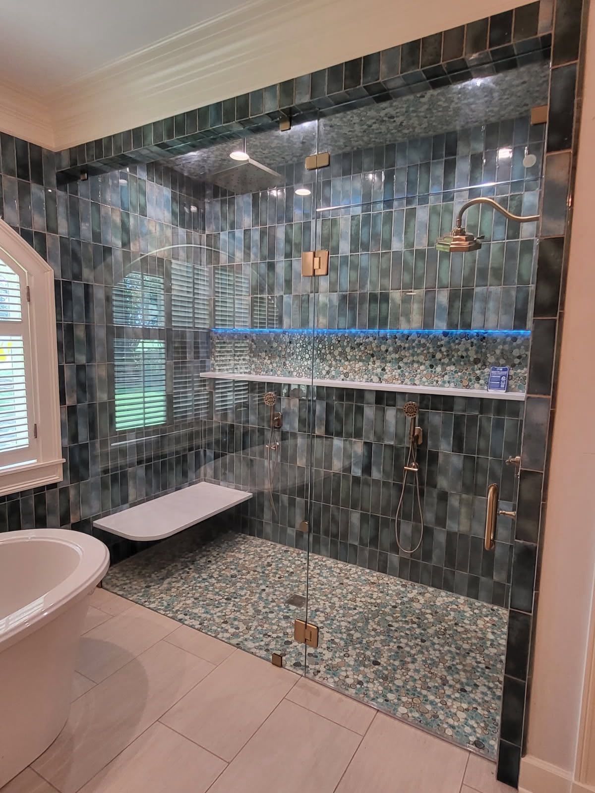 Walk-in shower with brass fixtures