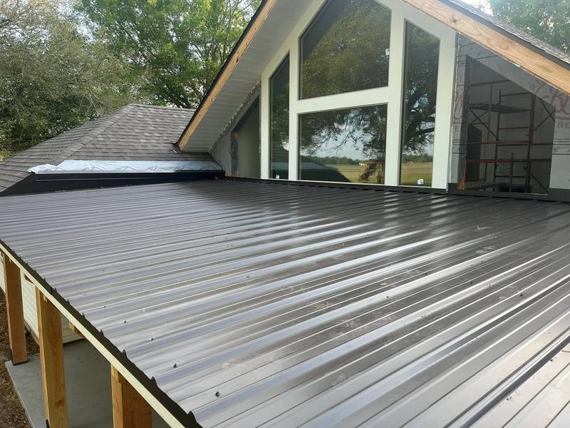 Home addition with tall gable windows and a new metal porch roof