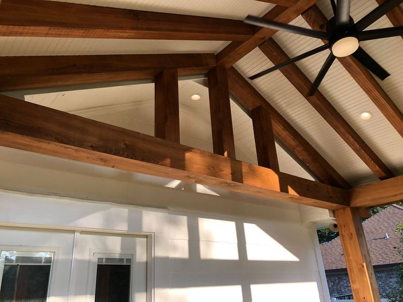 Exposed timber trusses with ceiling fan