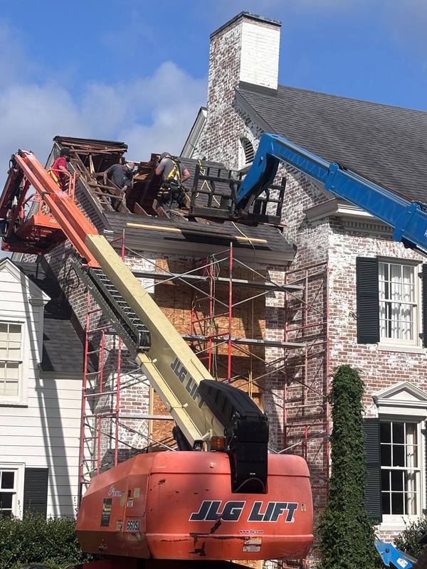 Lift and scaffolding on a brick chimney rebuild