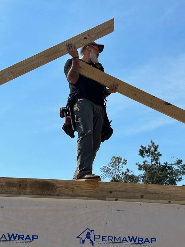 Carrying lumber across the top plate