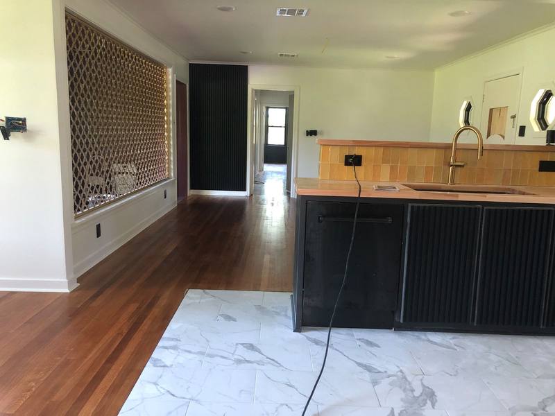 Open kitchen with marble floor and island