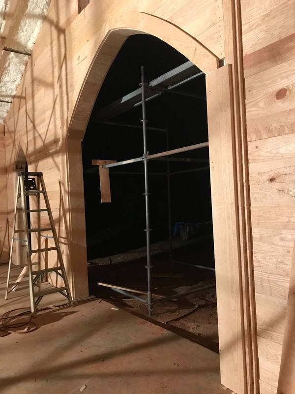 Arched opening framed in pine