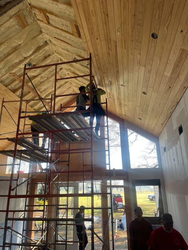 Installing a pine ceiling from the scaffold